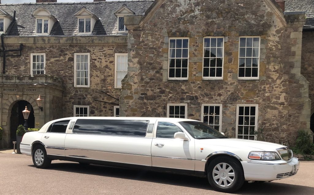 Reading Lincoln Town car beside park